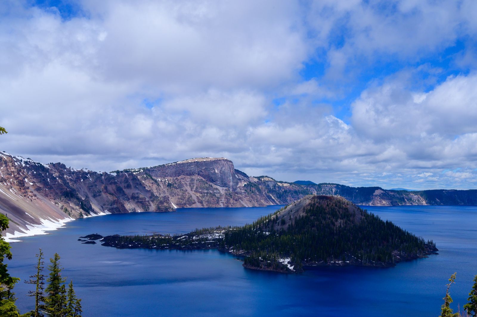 Wizard Island rising from the deep blue water of Crater Lake, one of the best places to visit in Oregon